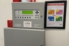 A fire alarm designed, installed and fitted in the communal area of a block of flats in Surbiton, Surrey