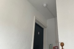 A fire alarm designed, installed and fitted in the communal area of a block of flats in Surbiton, Surrey